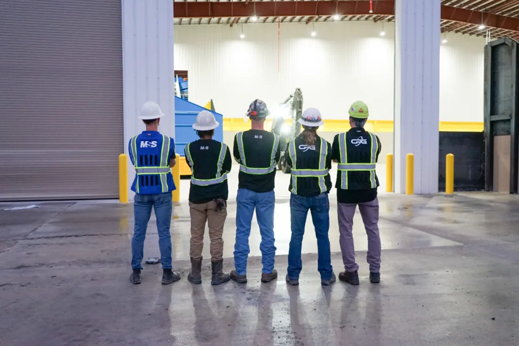 Men standing in front of a MRF in safety gear
