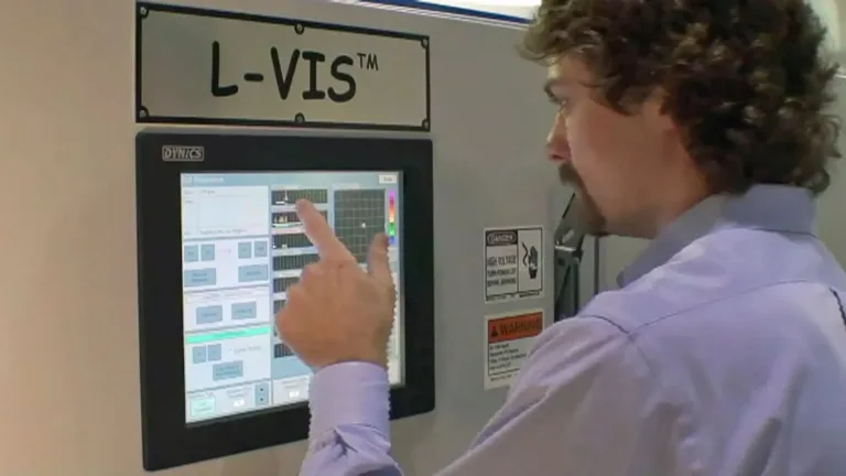 An image of a man pushing prompts on a L-VIS screen.