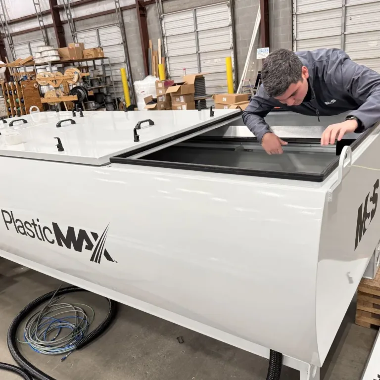 A worker doing maintenance on an optical sorting hood