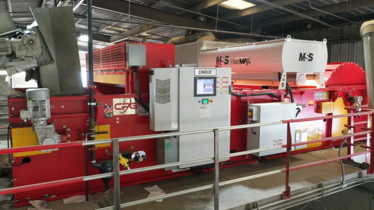 A red FiberMax unit on a platform in a recycling facility.
