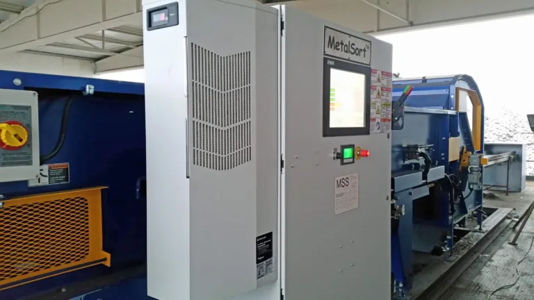Image of a MetalMiner recycling machine with the open door of a recycling facility