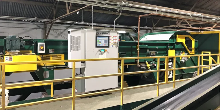 A green MetalMiner recycling unit on a MRF platform.