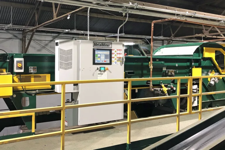 A green MetalMiner recycling unit on a MRF platform.