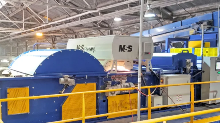 An image of a blue and yellow FiberMax unit in a platform in a MRF