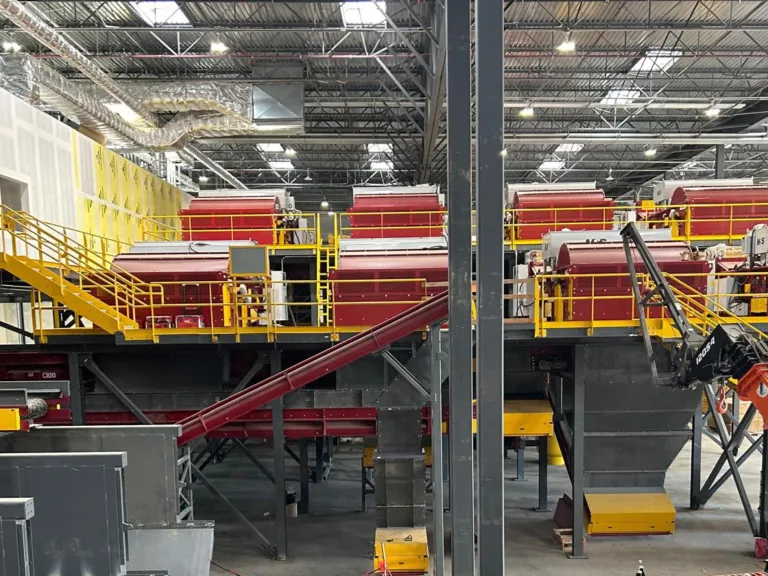 Overview of a red and yellow MRF system with a crane and an office