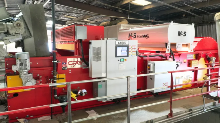 A red optical sorter FiberMax unit on a platform.