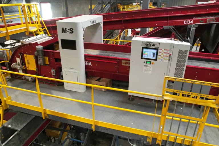 Image of a red Vivid AI unit in a recycling facility