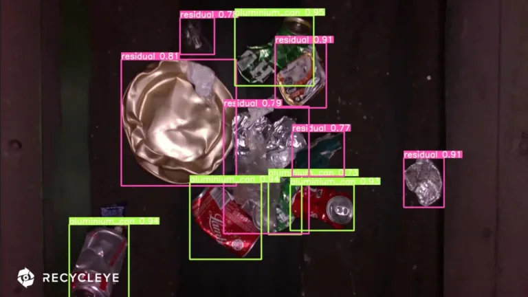 AI identification of materials with bounding boxes on a recycling belt.