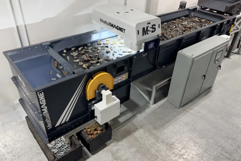 Overband magnetic separator labeled MeatballMAGNET MSS mounted over conveyor belt sorting metal scrap into separate bins.