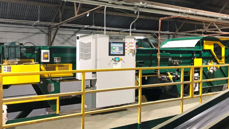 Image of a green MetalMiner recycling unit on a platform