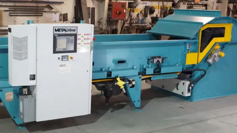 A light blue MetalMiner optical sorting unit in a warehouse