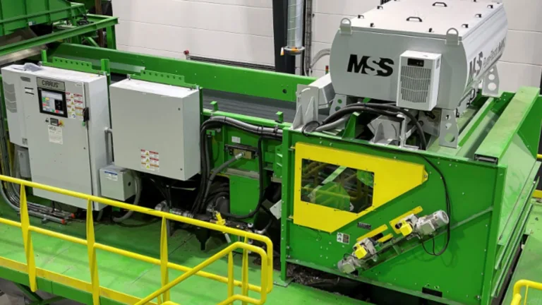 A high angle view of a green PurePlasticMax unit on a platform