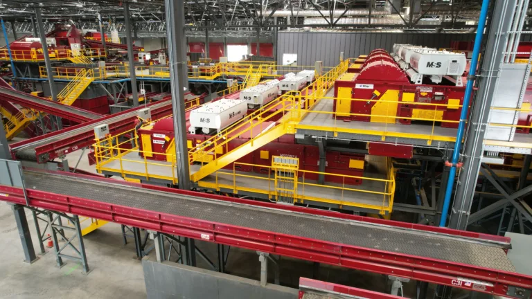 A system shot of red FiberMax optical sorters overlooking the container line